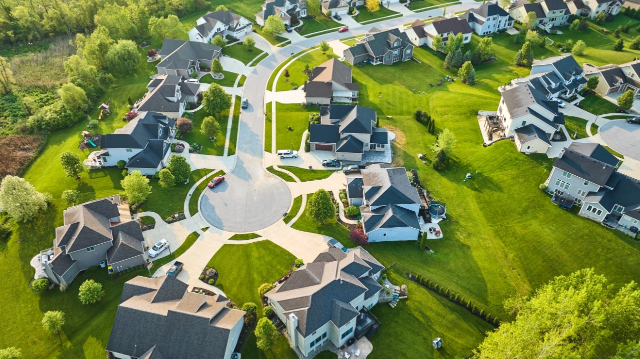 A view of houses from above with the sun shining.