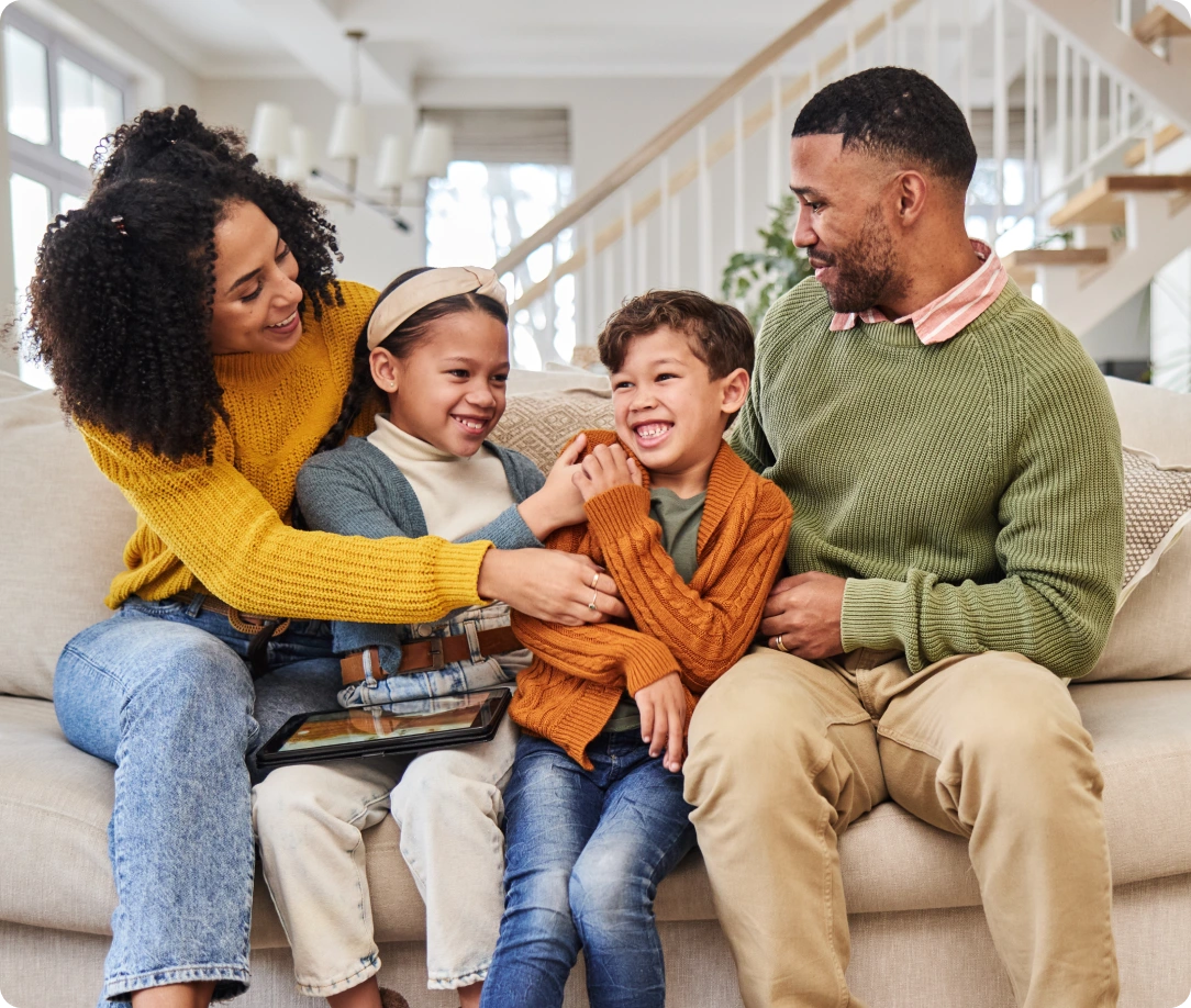 A family sitting on the couch together