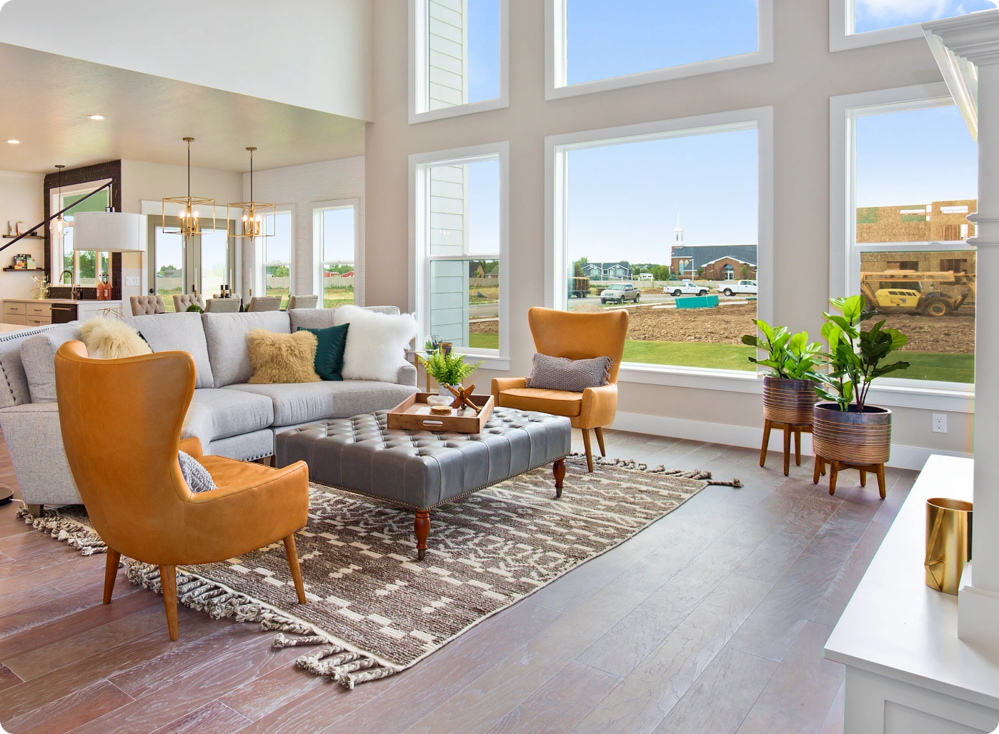 A living room with large windows and a couch