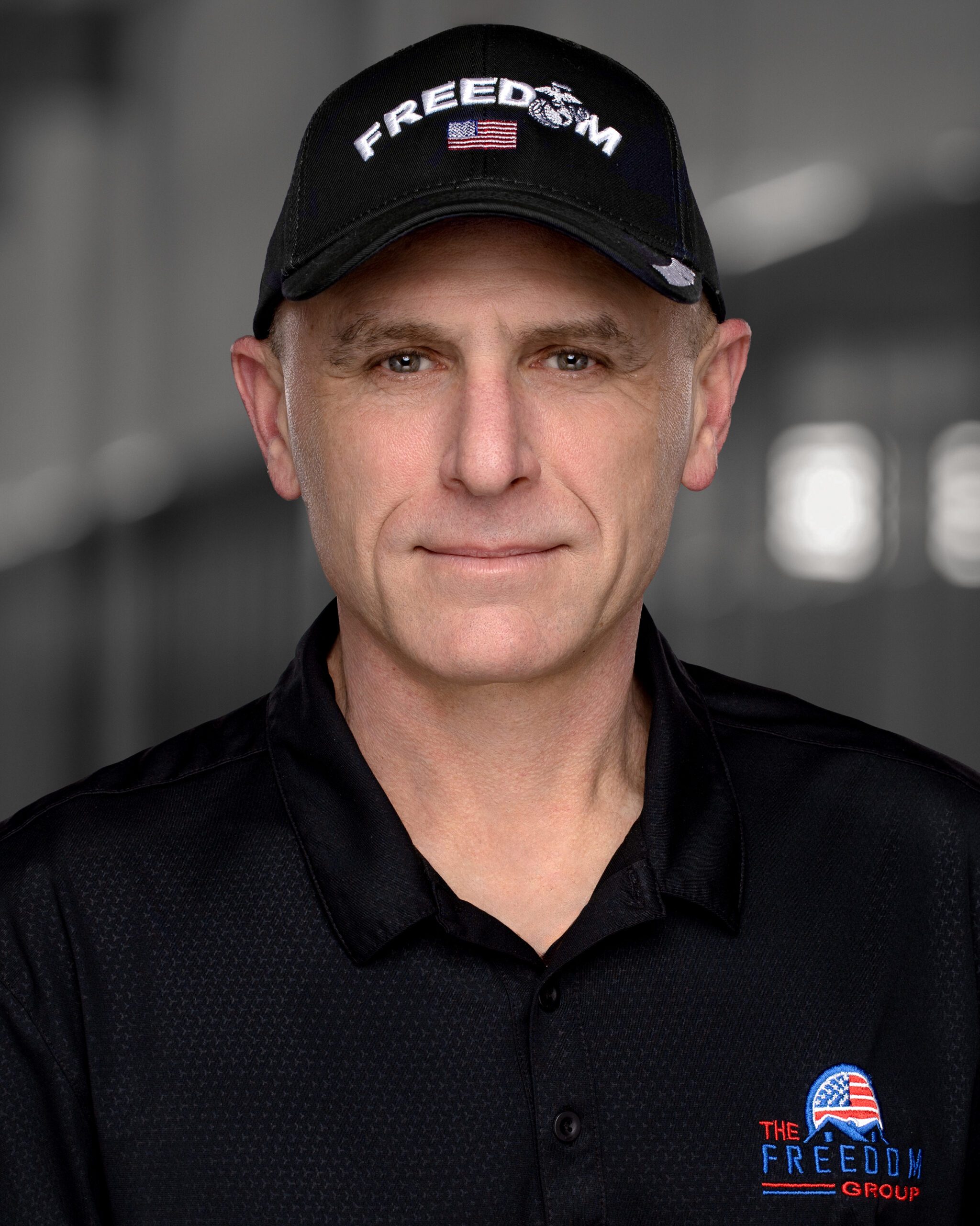 A man wearing a black shirt and hat.